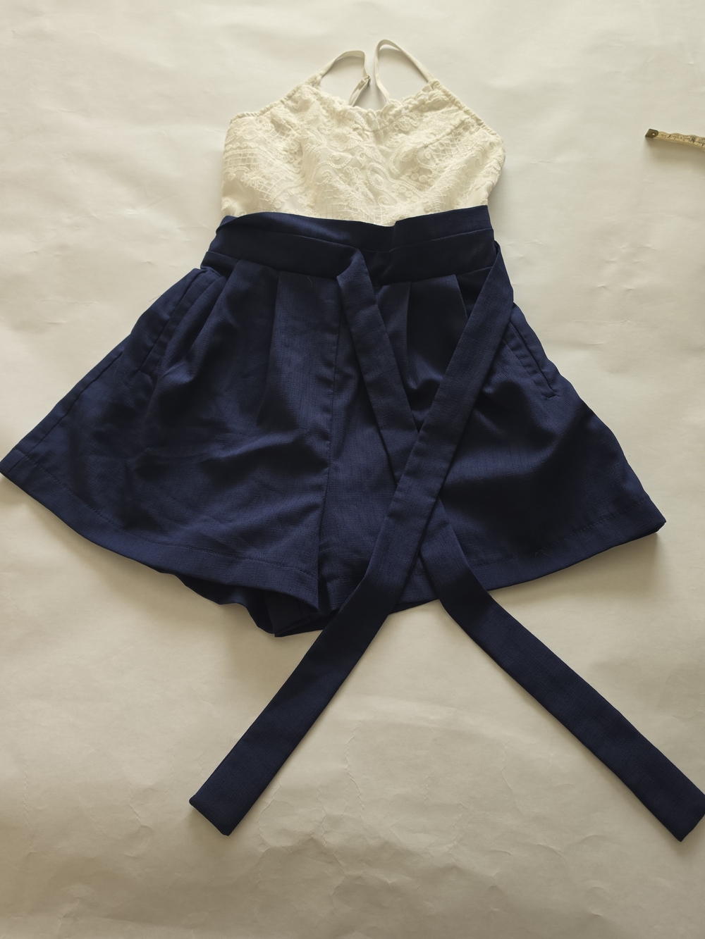 the clothing company Navy and White Lace Romper with Wrap Tie